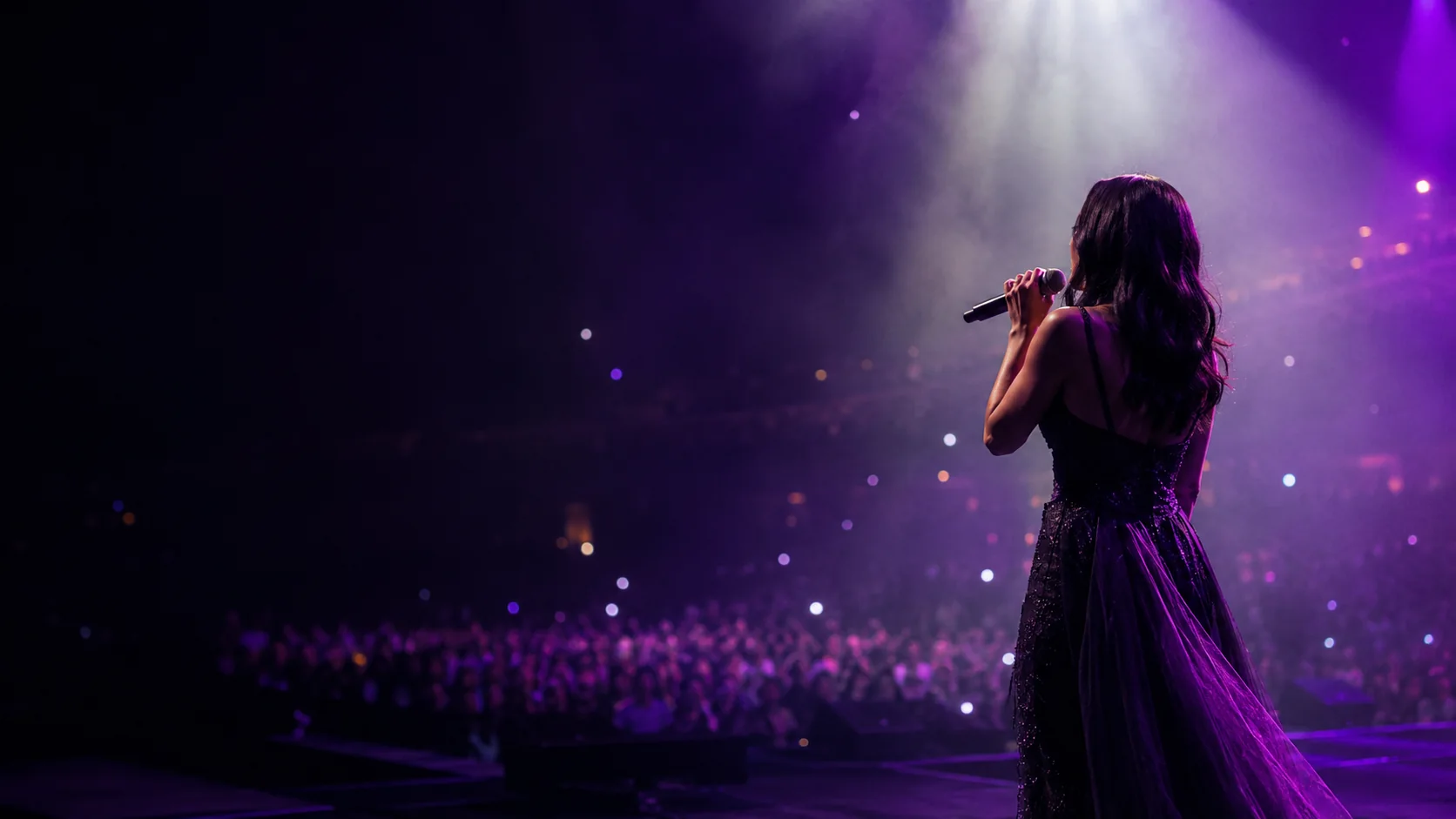 Masha Mnjoyan on stage under purple concert lighting